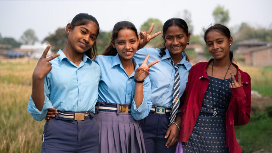 Four nepali girls in school uniforms pose for the camera, dreaming of changing the world.