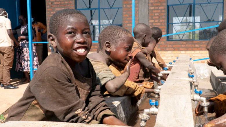 Children washing their hands.