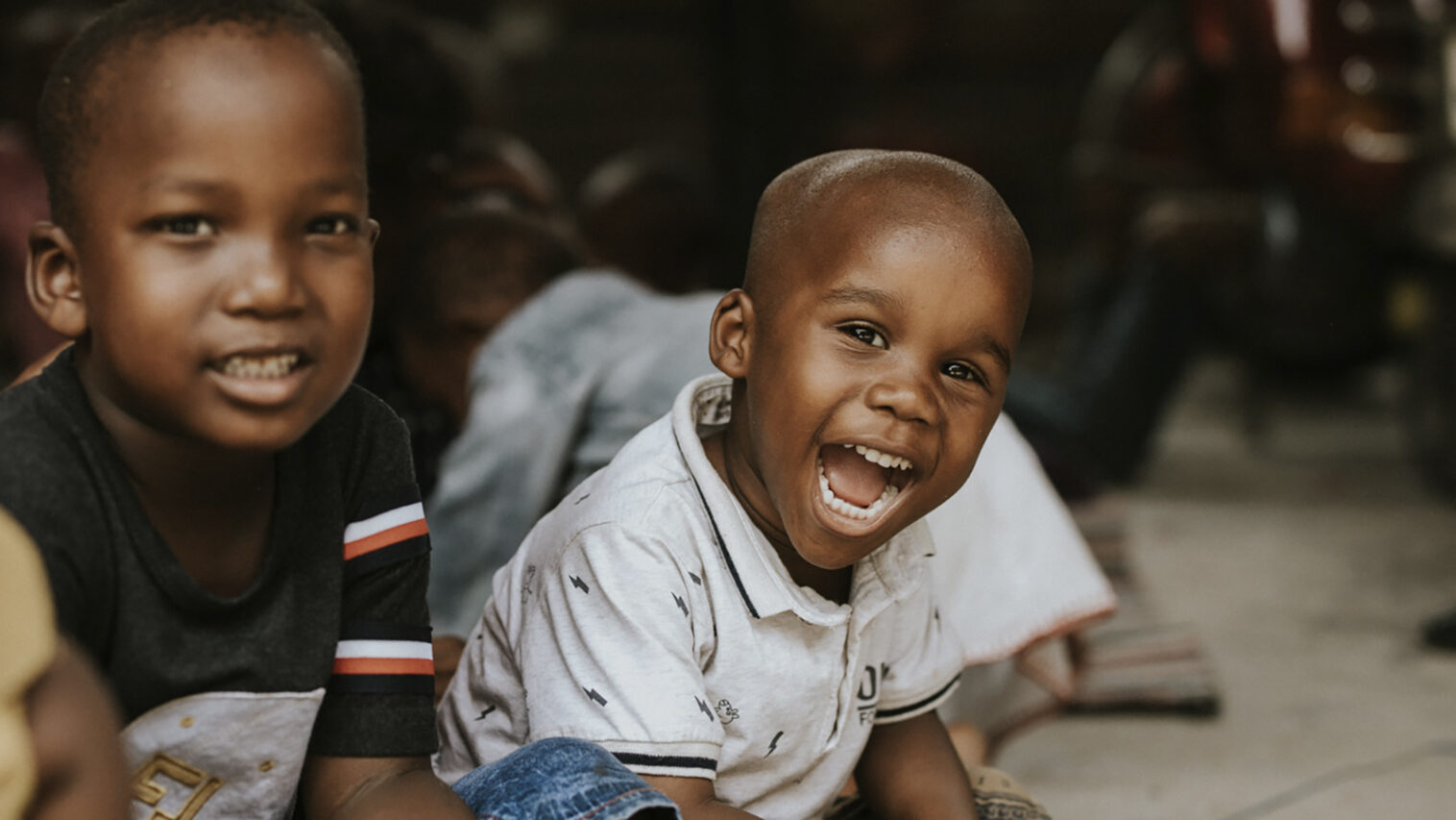 Two Tanzanian boys laughing.