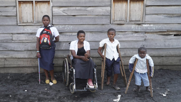 Four disabled children outside.