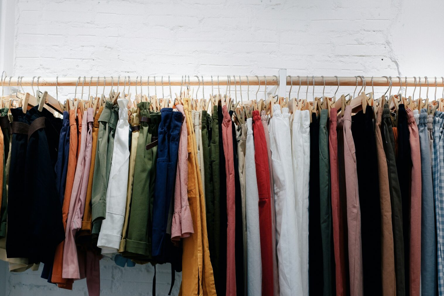 Clothes hanging in a row, on a rack